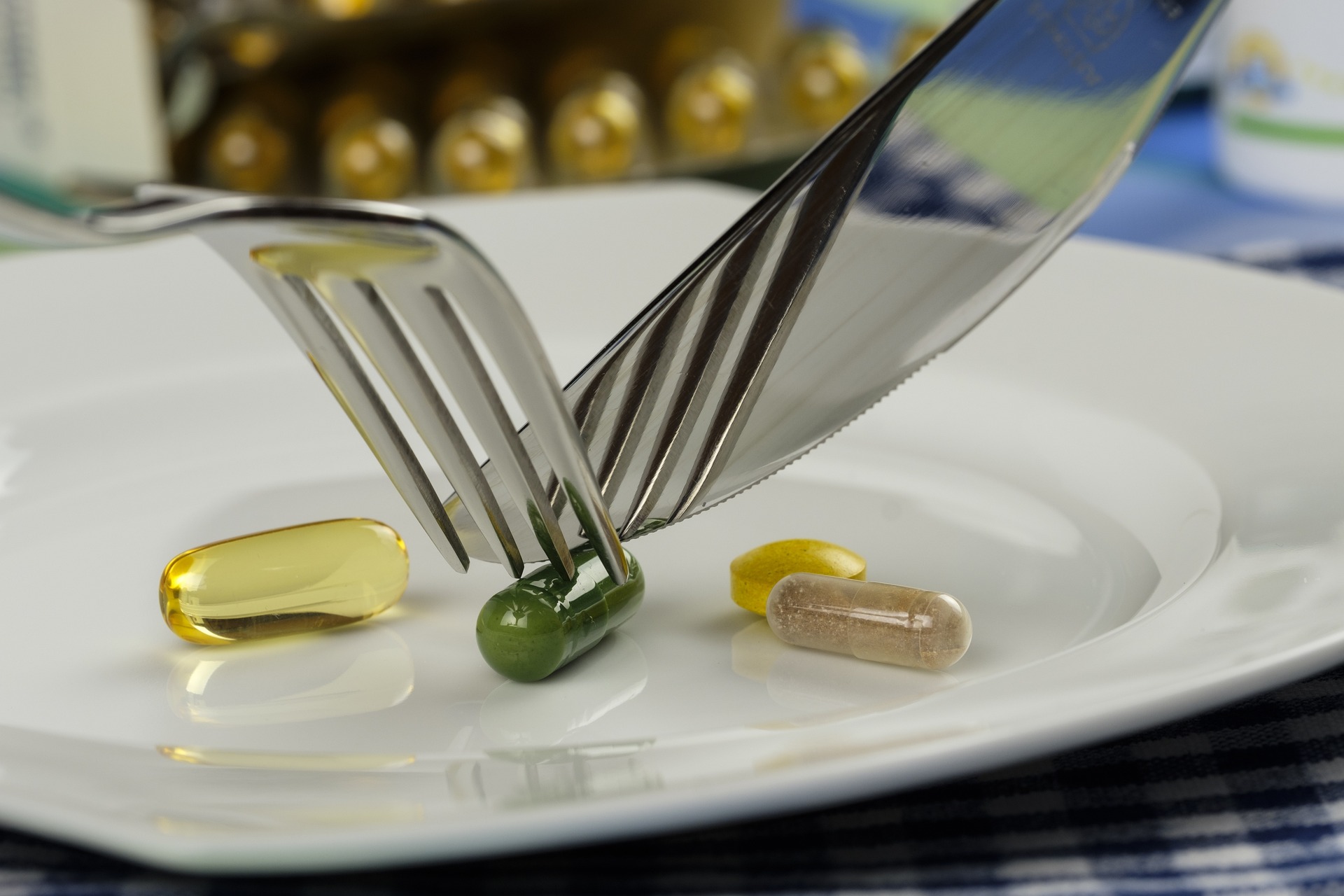 pills on a plate with knife and fork